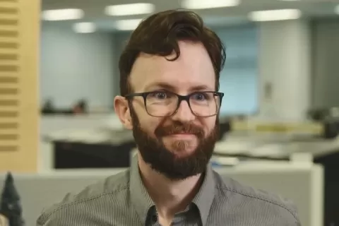 Gordon Douglas, a man with beard and glasses, smiles at camera
