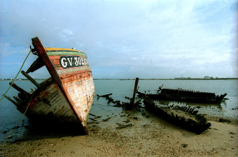 boat wreck lying on mudflat