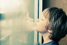 boy looking out a window