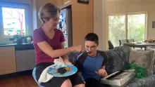 mother feeding (22 year old) autistic son 