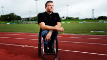 Kurt Fearnly in wheelchair on athletics track