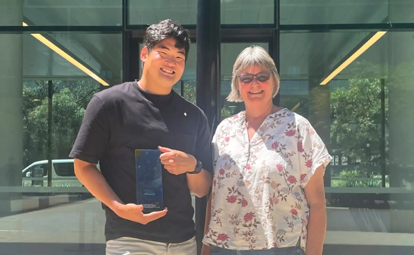 Daniel poses with the ACT Young Australian of the Year trophy, alongside his mother, Joanna.