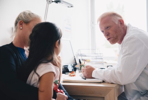 parents talking to clinician (in white coat)