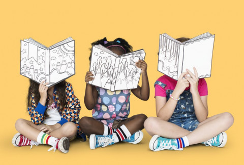 3 children sitting reading books