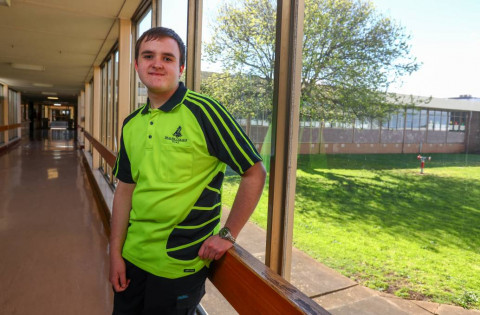 Former Brauer College student Bryce Pace wearing high visibility shirt looking at the camera