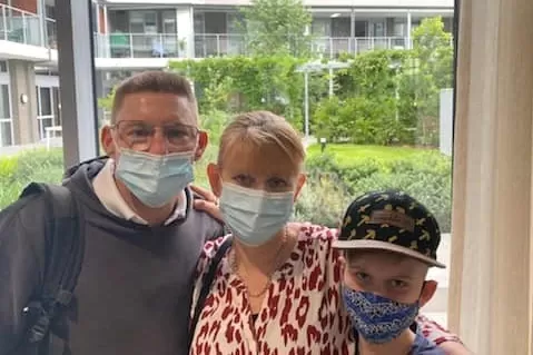 family of 3 wearing covid masks