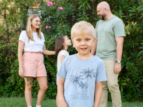 Eddie looking into the camera with his family behind him