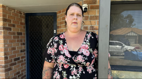 mother in floral dress facing camera