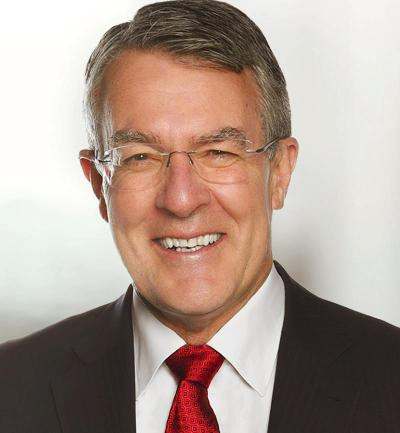 Attorney-General Mark Dreyfus smiling - suit, red tie, wire-rim glasses
