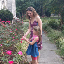 mother and daughter wearing summer clothes on a garden path