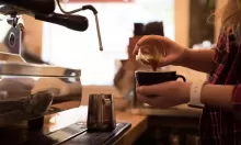 hands makinbg coffee at a coffee machine