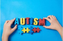 child's hands and letter-tiles saying "autism"